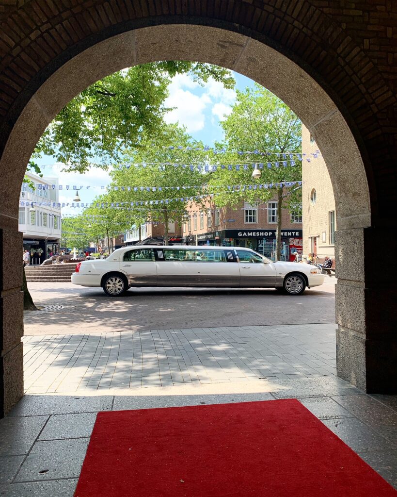 White limousine under archway entrance