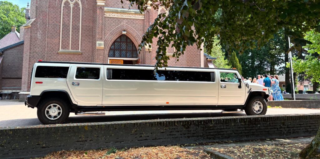 White Hummer limousine near church