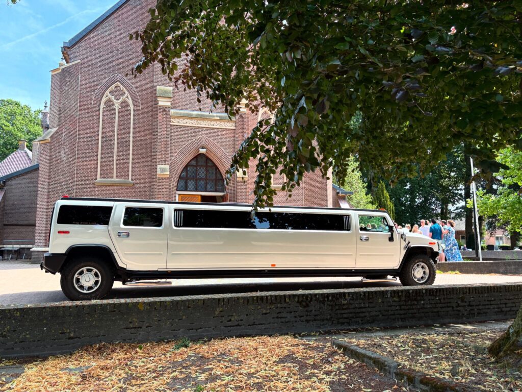 White Hummer limousine parked outside church