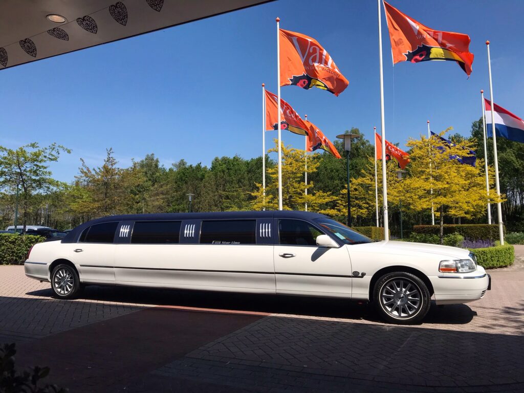 White limousine parked near flags