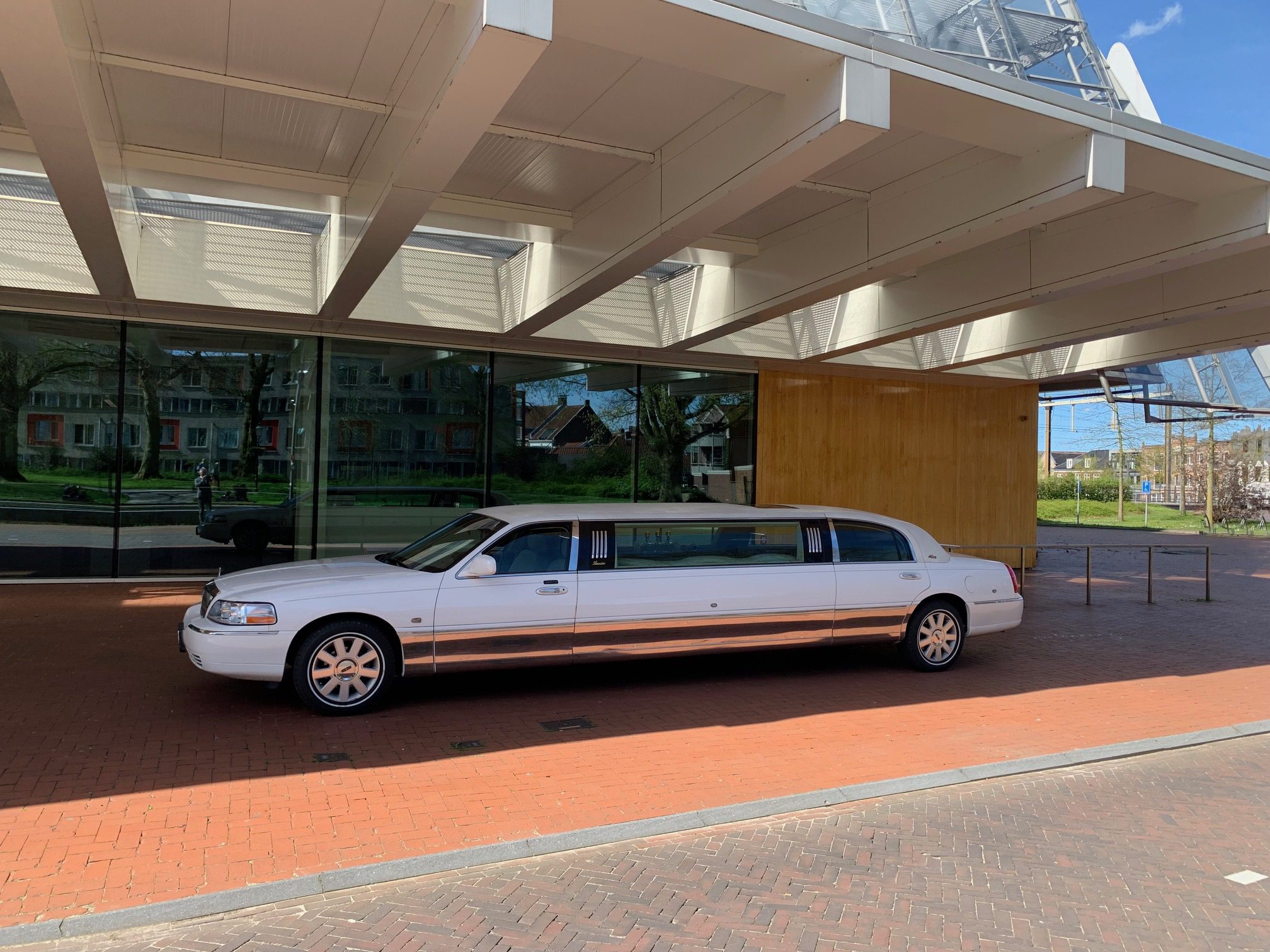 White limousine parked under canopy